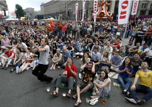 Soccer fans react as they watch Euro 2012 soccer match between Netherlands and Denmark in the fan zone in Kiev
