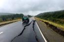 A damaged road is seen after a quake hit Chiloe island, southern Chile
