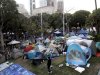 In this Nov. 2, 2011 photo, an Occupy Los Angeles protester walks past tents set up outside Los Angeles City Hall in Los Angeles. The Occupy Los Angeles encampment around City Hall will be cleared sometime next week, a city official and a lawyer for demonstrators said Wednesday, Nov. 23, 2011. (AP Photo/Jae C. Hong)