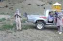 In this image taken from video obtained from the Voice Of Jihad Website, which has been authenticated based on its contents and other AP reporting, Sgt. Bowe Bergdahl sits in a vehicle guarded by the Taliban in eastern Afghanistan. The Taliban have released a video showing the handover of Bergdahl to U.S. forces in eastern Afghanistan. The video, emailed to media on Wednesday, shows Bergdahl in traditional Afghan clothing sitting in a pickup truck parked on a hillside. More than a dozen Taliban fighters with machine guns stand around the truck and on the hillside. (AP Photo/Voice Of Jihad Website via AP video)