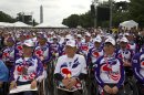 A group from the Paralyzed Veterans of Korea watch as President Barack Obama speaks on the 60th anniversary of the end of the Korean War, during remarks at a commemorative ceremony near the Korean War Veterans Memorial on the National Mall in Washington, on Saturday, July 27, 2013. (AP Photo/Jacquelyn Martin)