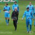 Netherlands' coach Van Marwijk walks as his players warm-up during a training session during the Euro 2012 at Wisla stadium in Krakow