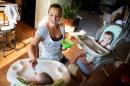 Heather Padgett feeds her daughters Kinsley and Kiley at her home in Cincinnati