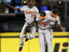 Baltimore Orioles outfielders Xavier Avery (70), Endy Chavez (27) and Nate McLouth celebrate after defeating the Seattle Mariners in a baseball game Monday, Sept. 17, 2012, in Seattle. Baltimore won 10-4. (AP Photo/Elaine Thompson)