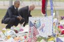 US President Barack Obama and Vice President Joe Biden place flowers for the victims of the mass shooting at a gay nightclub at a memorial in Orlando, Florida on June 16, 2016