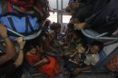 People from India's northeastern states sit inside train bound for Assam state at the railway station in Kolkata
