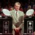 FILE - In this Jan. 3, 1996 file photo, Nebraska head football coach Tom Osborne stands between Nebraska's two National Championship trophies during the homecoming rally at the Devaney Sports Center in Lincoln, Neb. Osborne, the retired Nebraska coach isn’t getting drawn into arguments over how his 1990s teams that won three national championships in four years would fare against the Alabama teams that just accomplished the same feat. Osborne said Wednesday he admires what the Crimson Tide has done under Nick Saban. The Cornhuskers' 60-3 record from 1993-97 is the greatest five-year stretch in history. Alabama is 61-7 since 2008.   (AP Photo/Dave Weaver, File)