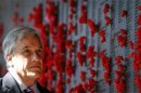 President of Chile, Pinera, inspects a wall covered with the names of fallen Australian soldiers as he tours the Australian War Memorial in Canberra