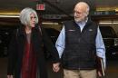 Alan and Judy Gross walk through a parking garage after arriving for a news conference in Washington