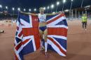 Britain's Jo Pavey celebrates with her country's flag after winning the gold medal in the women's 10,000m final during the European Athletics Championships in Zurich, Switzerland, Tuesday, Aug. 12, 2014. (AP Photo/Martin Meissner)