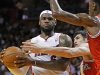 Miami Heat's LeBron James looks to pass as Milwaukee Bucks' Ilyasova and Sanders defend in the first half of their NBA basketball game in Miami, Florida