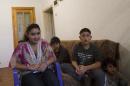 From left 15 year old Leonarda Dibrani, joined by her brothers Ronaldo 9, Roki 11, Masar 5, expelled from France last week, during an interview for The Associated Press in a room of a shelter house in Mitrovica, northern Kosovo, Wednesday, Oct 16, 2013. France's government, trying to save face amid widespread outrage, said Wednesday that it is investigating the treatment of a 15-year-old girl of the Dibrani family who was detained by police in front of her fellow students so she and her family could be expelled to Kosovo as illegal immigrants. (AP Photo/Visar Kryeziu)