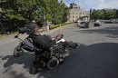 In this May 17, 2012 photo, Hairston Fullerton, a residing patient at Coler Goldwater Specialty Hospital & Nursing Facility on Roosevelt Island, drives his motorized wheelchair outside the facility's main entrance, in New York. The Technion-Israel Institute of Technology in Haifa, Israel, is partnering with New York's Cornell University to create CornellNYC Tech, a 10-acre $2 billion campus, to replace the acute long-term care hospital facility located on Roosevelt Island's southern end. (AP Photo/Bebeto Matthews)