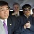 In this photo released by the US Embassy Beijing Press Office, U.S. ambassador to China, Gary Locke, left, makes a phone call as he accompanies blind lawyer Chen Guangcheng, right, in a car en route from the U.S. Embassy to a hospital in Beijing, Wednesday, May 2, 2012. At center is language attache James Brown. (AP Photo/U.S. Embassy Beijing Press Office, HO)