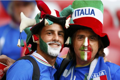 Fans of Italy's soccer team with their faces painted in national flag colors cheer before the start of Euro 2012 semi-final soccer match between Italy and Germany at National Stadium in Warsaw