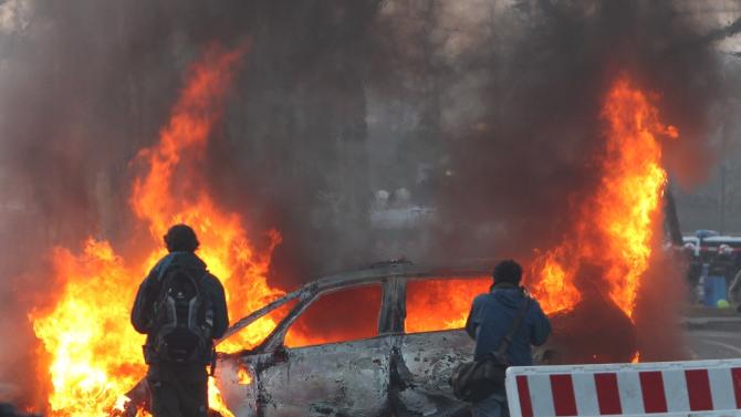 A police car was set on fire, windows were smashed and demonstrators threw stones at police in Frankfurt ahead of a massive anti-austerity rally marking the opening of the European Central Bank&#39;s new headquarters