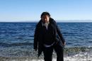 Chinese activist and artist Ai Weiwei walks on a beach near the town of Mytilene, on the Greek island of Lesbos on January 1, 2016