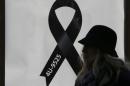 A woman walks past a black ribbon commemorating the 150 victims of Germanwings flight 4U 9525 outside Cologne's Cathedral