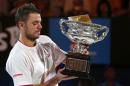 Stanislas Wawrinka of Switzerland poses with Norman Brookes Challenge Cup after defeating Rafael Nadal of Spain in their men's singles final match at the Australian Open 2014 tennis tournament in Melbourne