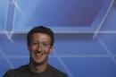 Facebook CEO Zuckerberg smiles in the stage before delivering a keynote speech during the Mobile World Congress in Barcelona