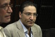 Egyptian journalist Islam Afifi appears in court during his trial in Cairo. Afifi was freed after a few hours in custody on Thursday, a security official said, following a presidential decree scrapping preventive detention for alleged publishing crimes. (AFP Photo/Ahmed Mahmud)
