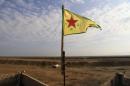 A YPG flag flutters on a lookout point between the Iraqi-Syrian border town of Rabia and the town of Snuny, north of Mount Sinjar