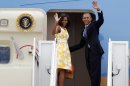 President Barack Obama and first lady Michelle Obama wave as they board Air Force One before departing Andrews Air Force Base, Md., Saturday, Aug. 10, 2013. The President and first lady are traveling to Orlando, Florida, where they will address injured veterans at the Disabled American Veterans National Convention, then follow on to their vacation at Martha's Vineyard. (AP Photo/Jose Luis Magana)