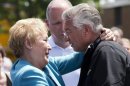 FILE- In this July 11, 2013, file photo, Raymond Lafontaine, who lost his son and two daughters-in-law, receives a hug from Quebec Premier Pauline Marois during her visit to Lac-Megantic, Quebec as Marois toured the site where a runaway oil train killed 50 people in a fiery explosion. (AP Photo/The Canadian Press, Ryan Remiorz, File)