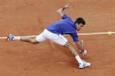 Djokovic of Serbia hits a return to Pella of Argentina during their men's singles match at the French Open tennis tournament in Paris