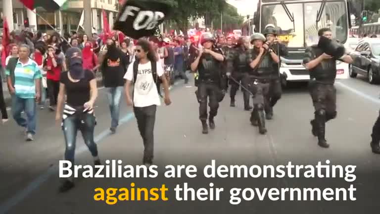 Angry residents battling with cuts to education and health services take to the streets of Rio de Janeiro in protest over a government spending for the Olympics.