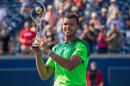 Jo-Wilfried Tsonga holds the Rogers Cup after defeating Roger Federer of Switzerland 7-5, 7-6 in the final of the Rogers Cup at Rexall Centre in Toronto, Ontario, August 10, 2014