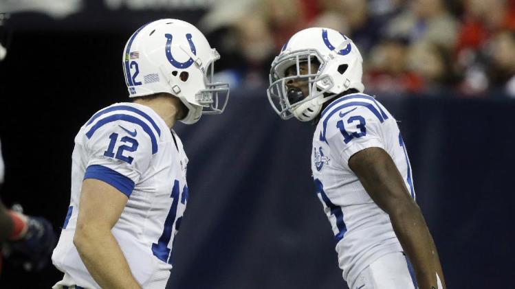 CORRECTS FIRST NAME FROM T.J. YATES TO T.Y. HILTON  - Indianapolis Colts' Andrew Luck (12) and T.Y. Hilton (13) celebrate after they connected for a touchdown against the Houston Texans during the fourth quarter of an NFL football game Sunday, Nov. 3, 2013, in Houston