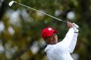 U.S. golfer Woods hits his tee shot on the third hole during the morning foursomes round at the 39th Ryder Cup golf matches at the Medinah Country Club