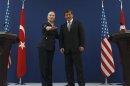 U.S. Secretary of State Clinton and Turkish Foreign Minister Davutoglu pose for the media after their news conference