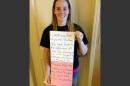 FILE - This March 2, 2014, file photo, provided by Katheryn Deprill that she posted on Facebook, shows Deprill holding a sign that says she is seeking her birth mother. Deprill was abandoned in the bathroom of a Burger King restaurant in Allentown, Pa., when she was a few hours old. Deprill tells The Associated Press that she met her biological mother for the first time Monday, March 24, 2014, in an attorney's office. Deprill said Tuesday that she felt 
