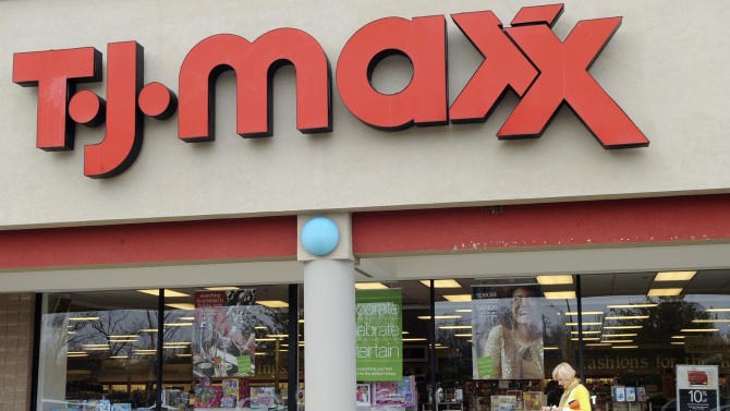 FILE - In this Nov. 17, 2009 file photo, a customer walks past a T.J. Maxx store in Boston. TJX Cos., the owner of T.J. Maxx, Marshalls and Home Goods stores, on Wednesday, Feb. 25, 2015 said it will boost pay for U.S. workers to at least $9 per hour. (AP Photo/Lisa Poole, File)