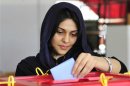 A woman casts her vote at a polling station during the National Assembly election in Benghazi