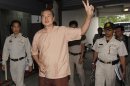 Somyot, editor of "Voice of the Oppressed" gestures as he arrives at the criminal court in Bangkok