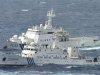 A Chinese marine surveillance cruises next to a Japan Coast Guard patrol ship in the East China Sea, known as the Senkaku isles in Japan and Diaoyu islands in China