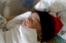 New Mexico's first New Year's Day baby Angelo Oros, sleeps Thursday, Jan. 1, 2015, at San Juan Regional Medical Center in Farmington, N.M. Oros was born at 12:00:45 a.m. weighing in at 7lbs. 14oz. (AP Photo/The Daily Times, Alexa Rogals)