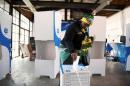 A women wearing ANC regalia casts her vote during the local government elections in Hillbrow, central Johannesburg, South Africa