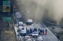 Police vehicles are parked at the entrance as smoke billows out of the Sasago Tunnel on the Chuo Expressway in Koshu, Yamanashi Prefecture, central Japan, Sunday morning, Dec. 2, 2012. A part of the tunnel collapsed Sunday morning, possibly involving several vehicles and injuring several people, local media said. (AP Photo/Kyodo News) JAPAN OUT, MANDATORY CREDIT, NO LICENSING IN CHINA, FRANCE, HONG KONG, JAPAN AND SOUTH KOREA