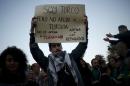 Serdar Ocaksonmez, a Turk living in Malaga, holds a sign during a protest against the EU-Turkey migrant deal in Malaga