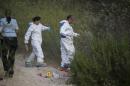Forensic team members work near the place where a body was found next to Ein Karem
