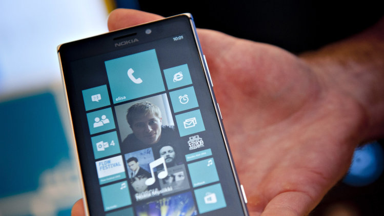 In this Aug. 15, 2013 photo, Nokia's Lumia 925 phone is shown at the flagship store of Finnish mobile phone manufacturer Nokia in Helsinki, Finland. Microsoft Corp. is buying Nokia Corp.'s devices and services business, and getting access to the company's patents, for a total of 5.44 billion euros ($7.2 billion) in an effort to expand its share of the smartphone market, the companies announced late Monday, Sept. 2, 2013. (AP Photo/Lehtikuva, Mikko Stig) FINLAND OUT