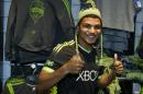 FILE - In this March 3, 2014 file photo, Seattle Sounders' DeAndre Yedlin adds a hat to his modeling of the MLS soccer team's new "third kit" uniform at the CenturyLink Field Pro Shop in Seattle. Yedlin is back with the Sounders but far more known than when he left for U.S. national team camp nearly two months ago. After an impressive performance in the World Cup, the question now is how long can Seattle hold on to its budding homegrown star? (AP Photo/Ted S. Warren, File)