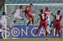 Qatar's Ibrahim Majed, center, leaps in the air as he battles for the ball with Bahrain's players during their AFC Asia Cup soccer in Sydney, Australia, Monday, Jan. 19, 2015. (AP Photo/Rick Rycroft)