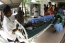 Paramedics attend to a woman wounded during an attack on the African Inland Church in Garissa