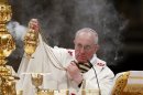 Pope Francis holds the incense burner as he leads a vigil mass during Easter celebrations at St. Peter's Basilica in the Vatican
