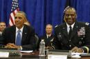 U.S. President Barack Obama sits next to Commander of Central Command Gen. Lloyd Austin III during in a briefing from top military leaders while at U.S. Central Command at MacDill Air Force Base in Tampa
